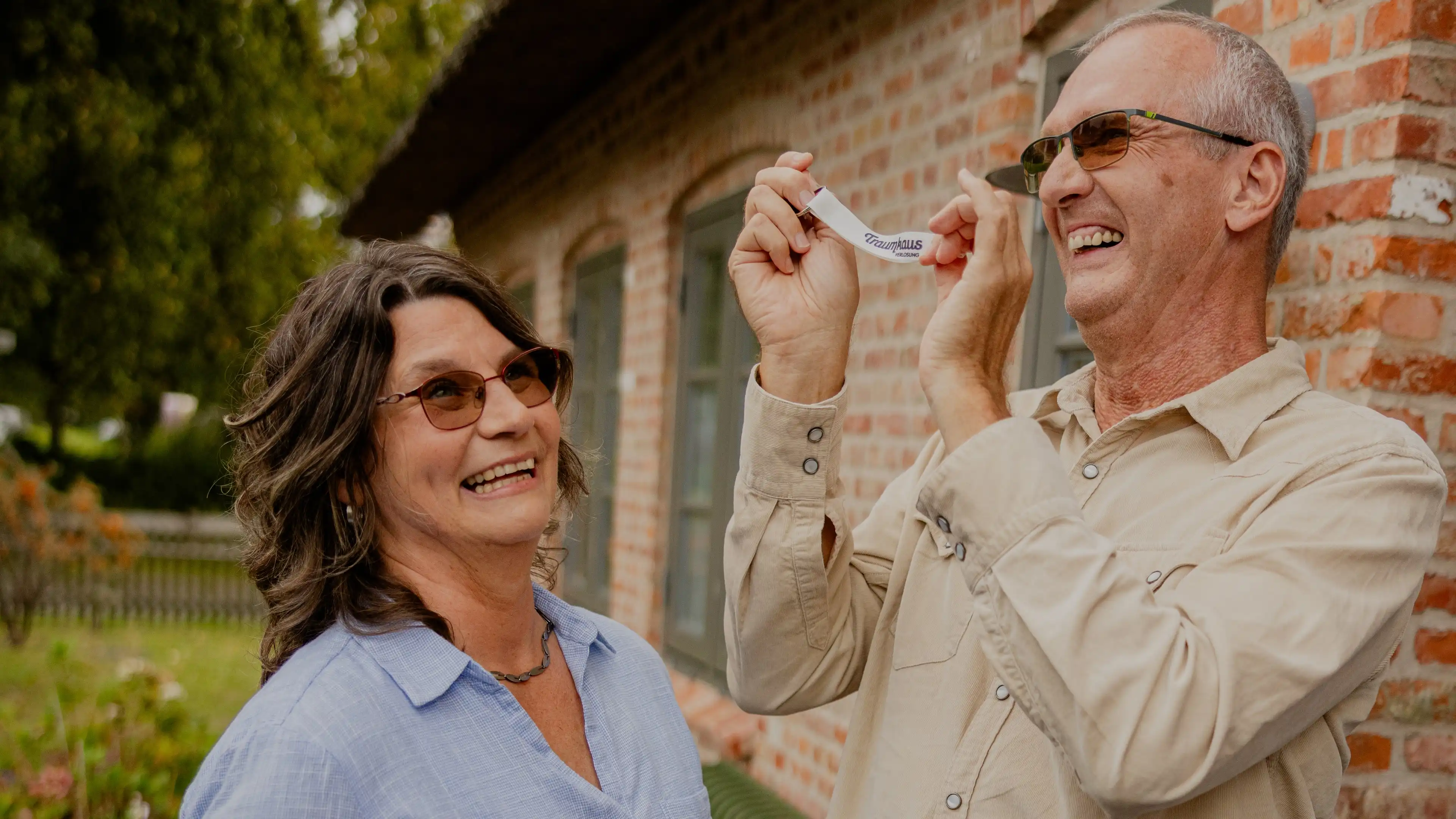 Thomas, Gewinner des Nordsee-Traumhauses und seine Frau halten den Schlüssel für ihr neues Traumhaus in den Händen