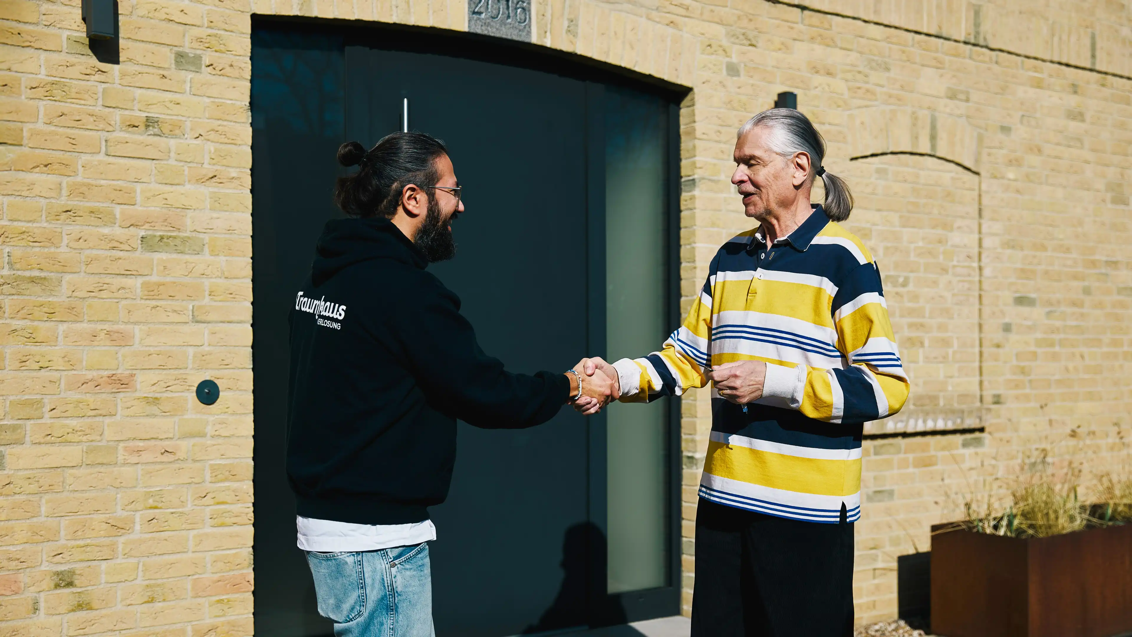 Omid und Jürgen, der Gewinner des Förde-Hauses bei der Schlüsselübergabe